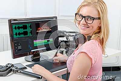 Young woman designer using computer for the video editing Stock Photo