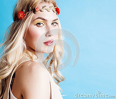 young blond woman dressed like ancient greek godess, beautiful girl hands manicured red nails on blue background Stock Photo