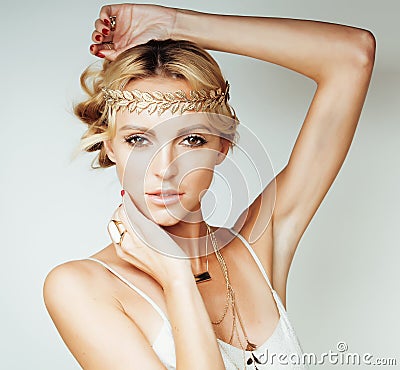 Young blond woman dressed like ancient greek godess, gold jewelry close up isolated Stock Photo