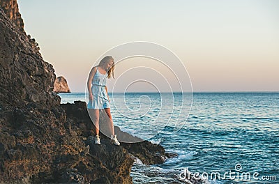 Young blond woman looking at still water, Alanya, Turkey Stock Photo