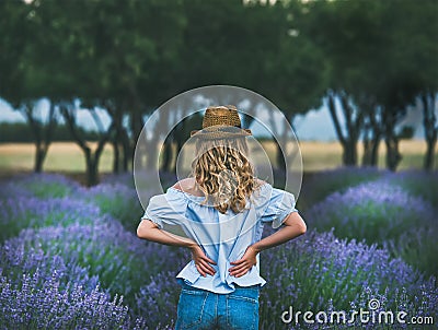 Young blond woman traveller standing in lavender field in Turkey Stock Photo