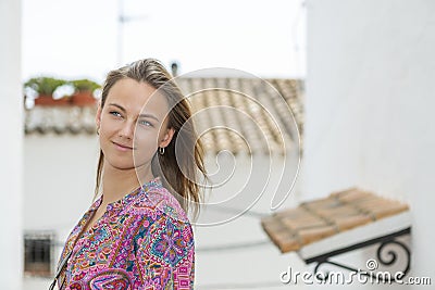 Pretty young blonde in an alley in mediterranean village Stock Photo