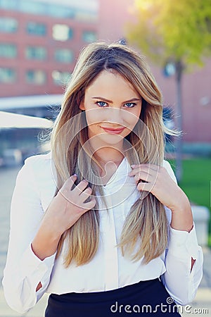 Young blonde businesswoman in park smile Stock Photo