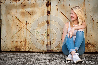 Young blonde caucasian girl alone on a street Stock Photo