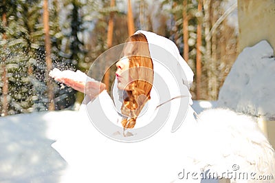 young blonde christmas angel blowing on the snowflakes Stock Photo