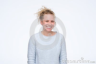 Young blonde curly laughing woman having positive mood. Stock Photo