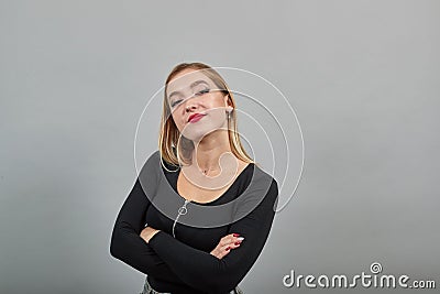 Young blonde girl in black jacket beautiful woman crossed her arms Stock Photo