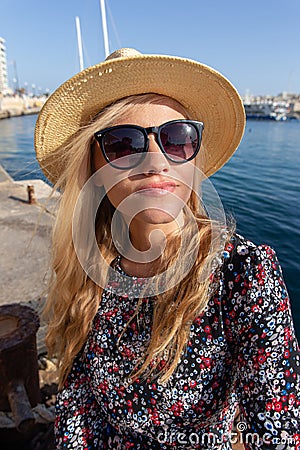 Young blonde Mediterranean traveler woman in hat portrait Stock Photo