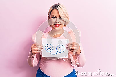 Young blonde plus size woman asking for positive change holding paper with emotion message looking positive and happy standing and Stock Photo