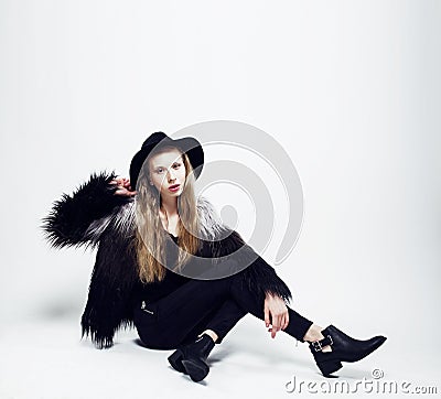 Young blonde teenage girl in hat and fur coat, fashion dressed m Stock Photo