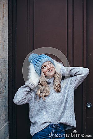 Blonde woman in blue knitted hat Stock Photo