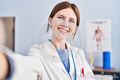 Young blonde woman physiotherapist smiling confident make selfie by camera at rehab clinic Stock Photo