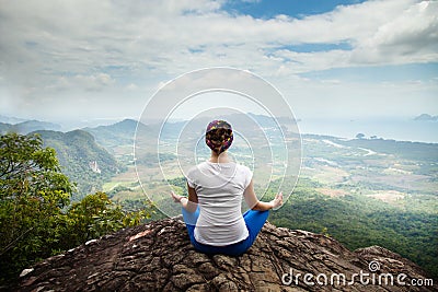 Young blonde woman practicing yoga and meditation in mountains during luxury yoga retreat in Bali, Asia Stock Photo