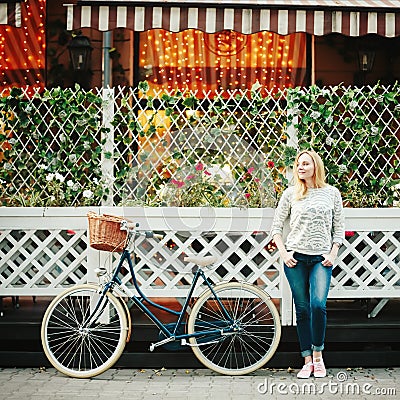 Young blonde woman on a vintage bicycle Stock Photo