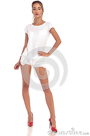 Young blonde woman in white shorts and shirt Stock Photo