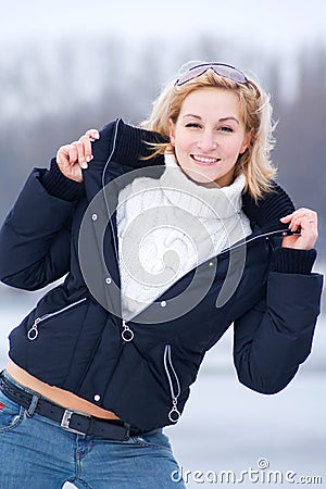 Young blonde woman in wide opened black jacket Stock Photo