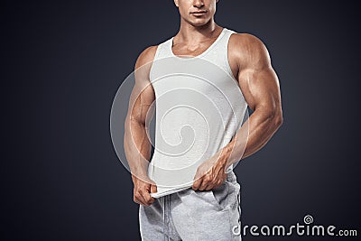 Young bodybuilder wearing white sleeveless t-shirt Stock Photo