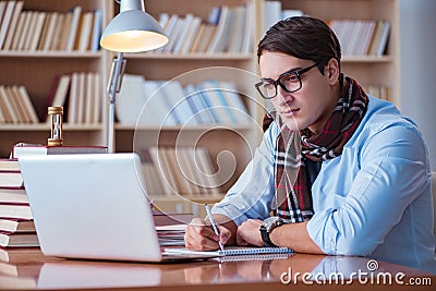 The young book writer writing in library Stock Photo