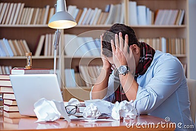 The young book writer writing in library Stock Photo