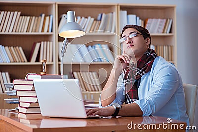 The young book writer writing in library Stock Photo