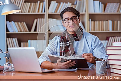 The young book writer writing in library Stock Photo