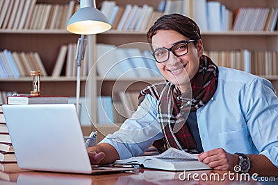 The young book writer writing in library Stock Photo