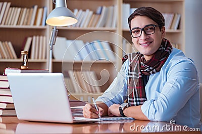 The young book writer writing in library Stock Photo