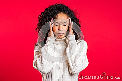 Young bored afro woman with long hair having headache, studio portrait Stock Photo