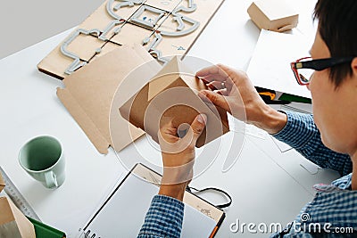 Young box designer looking at the folding of the product Stock Photo