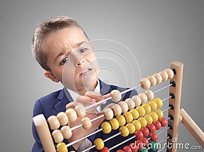 Young boy accountant businessman does calculation on a abacus Stock Photo