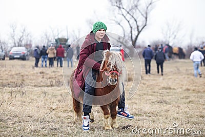 Young boy is bareback riding a pony before an Epiphany celebration horse race Editorial Stock Photo