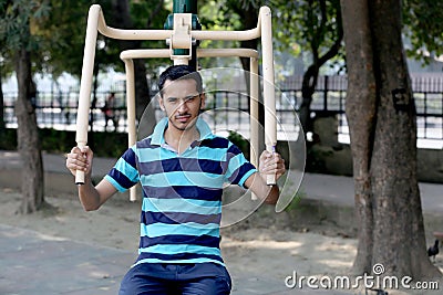 A young boy doing exercise in public park Delhi in India. Editorial Stock Photo