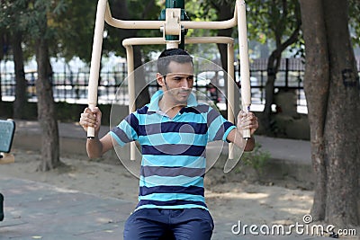 A young boy doing exercise in public park Delhi in India. Editorial Stock Photo