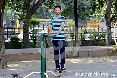 A young boy doing exercise in public park Delhi in India. Editorial Stock Photo