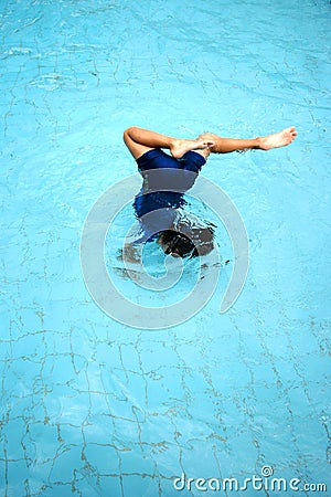 A young boy doing a somersault in the swimming pool Stock Photo