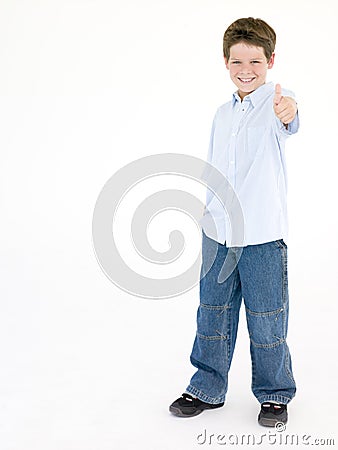 Young boy giving thumbs up smiling Stock Photo