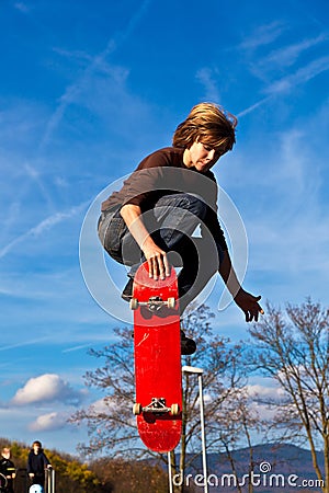 Young boy going airborne with his skateboard Stock Photo