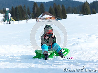 Young boy have fun on winter vacatioin and play games on phone Stock Photo