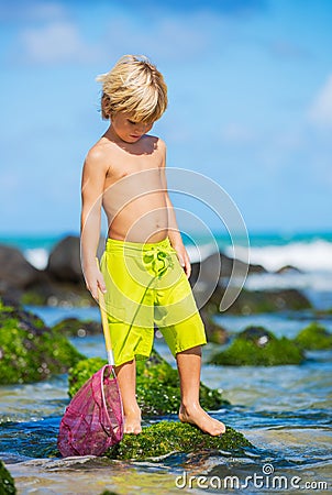Young boy having fun on tropcial beach Stock Photo