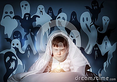 Young boy hiding under blanket Stock Photo