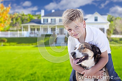 Young Boy and His Dog in Front of House Stock Photo