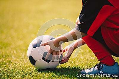 Young boy holding football ball. Soccer sports background Stock Photo