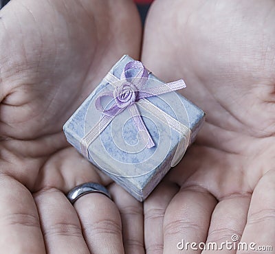 A young boy holds a vintage gift box in his hands Stock Photo