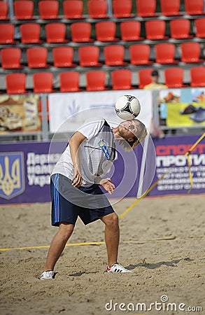 Young boy juggling with the soccer ball on the beach stadium Editorial Stock Photo