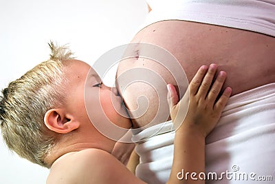 Young boy is kissing the belly Stock Photo