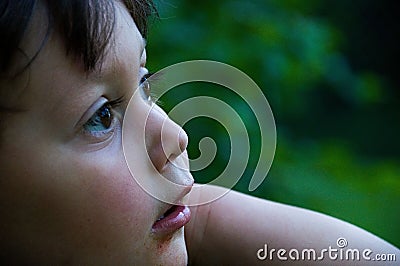 Young boy looking in a different direction from the camera, lost in thought Stock Photo
