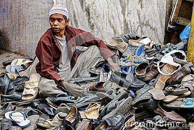Young boy looking after shoes outside Ajmer mosque Editorial Stock Photo