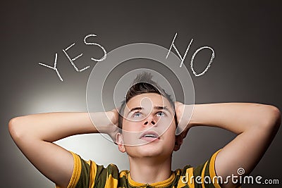 Young boy looking up at Yes and No Stock Photo