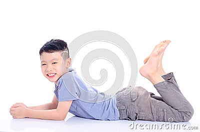 Young boy lying down on the floor Stock Photo