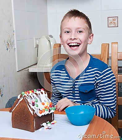 Young boy making gingerbread house Stock Photo